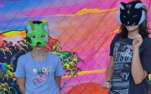 Two young teens in homemade fox facemasks