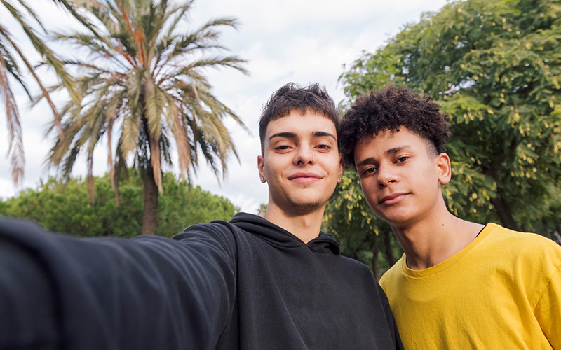 Two early 20's women with short hair doing a selfie